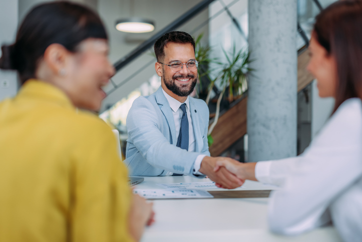 businessman shaking hands with clients