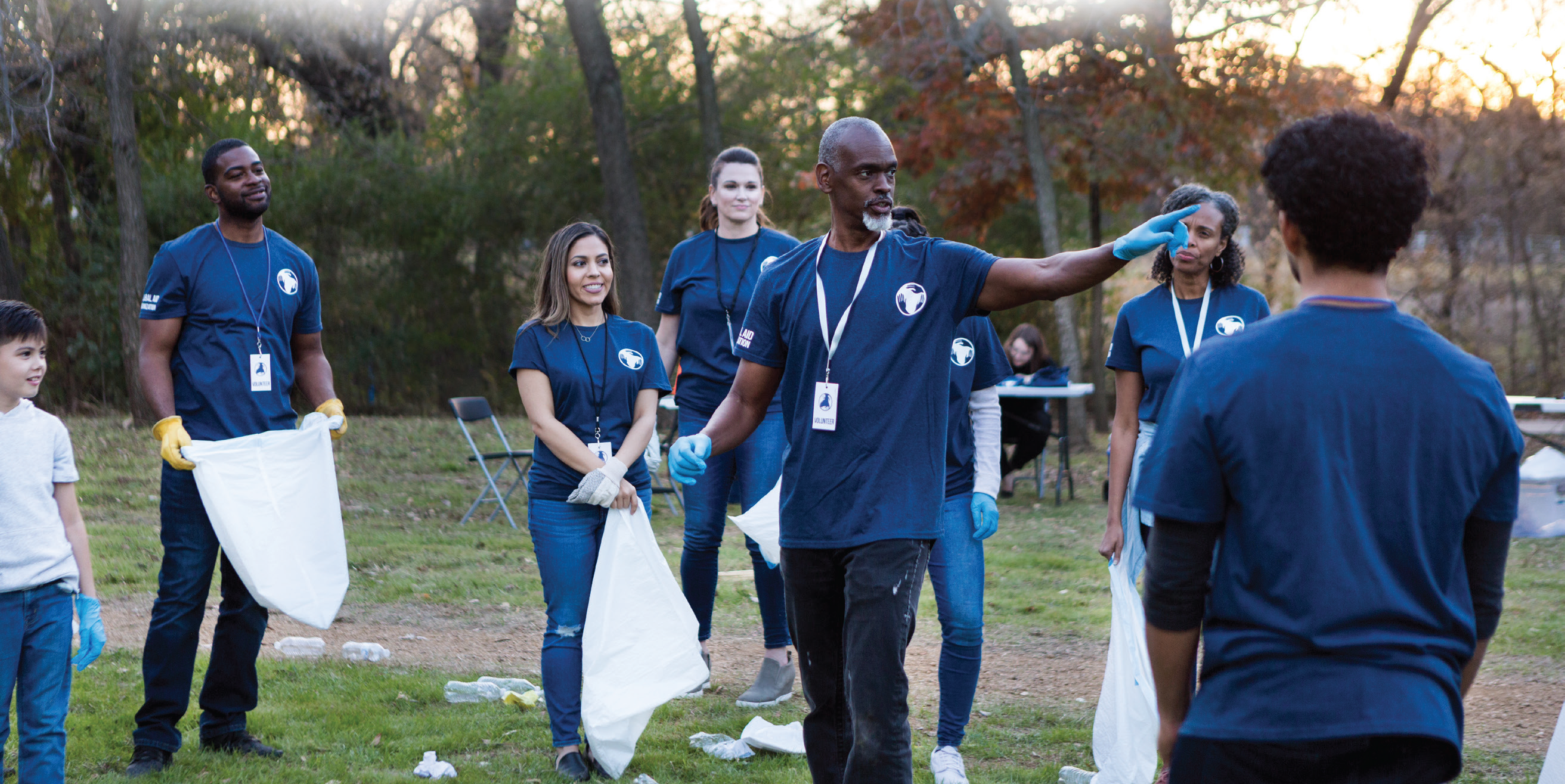 group holding trash bags getting ready to help community