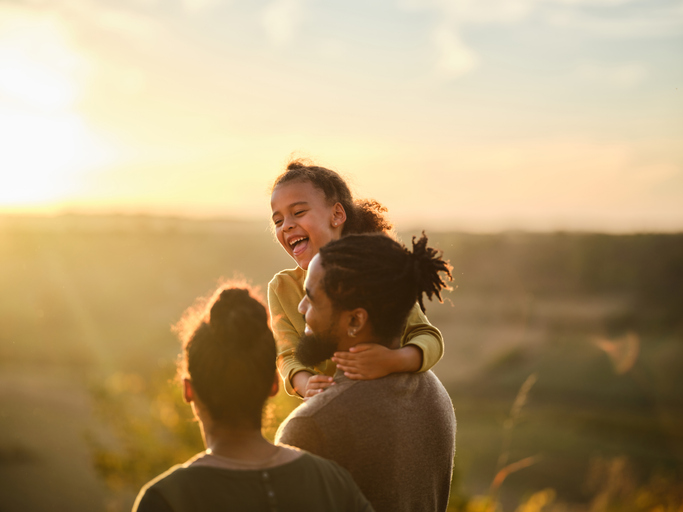 happy family walking during sunset