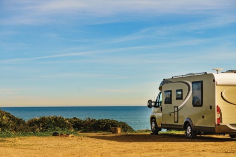 RV on a road facing beautiful water bay