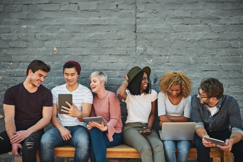 A group of millennials discussing insurance options.