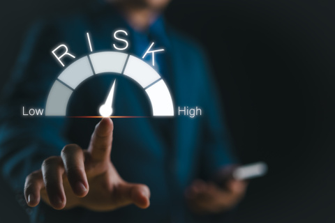 Businessman touching risk level indicator virtual rating low to high 