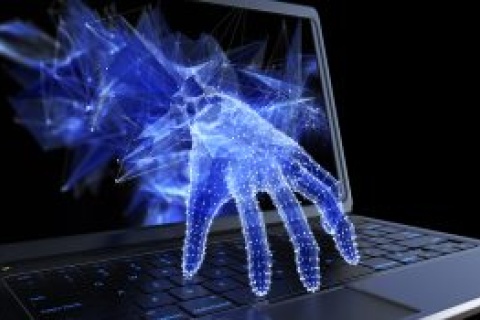 Virtual hand coming out of a laptop screen to represent cybersecurity concerns independent insurance agents face.