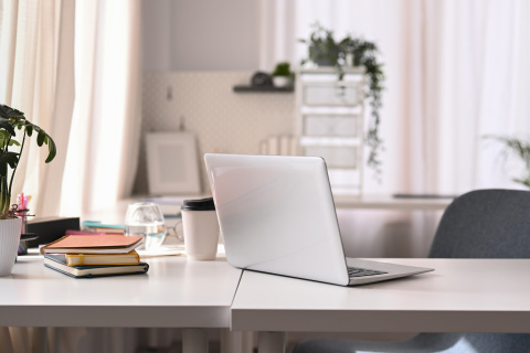 Clean, modern desk with open laptop