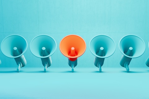 A collection of megaphones against a blue background, representing new agents building community connections and taking charge of their own lead generation, highlighting the industry's risks and the importance of making a strong impact as and insurance agent in the field.