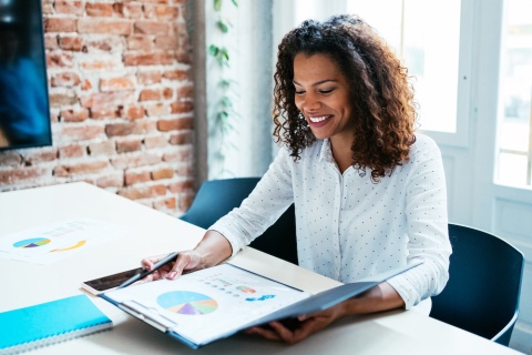 An independent insurance agent reviewing charts to determine if an insurance agency cluster is good for her agency's growth.