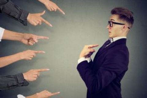 Fingers pointing at an independent insurance agent who needs to take responsibility for his performance.