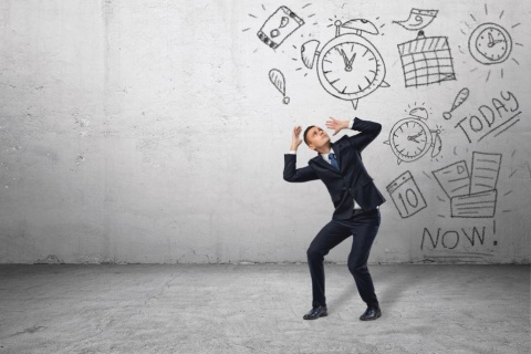 Man in suit ducking below sketches of clocks, calendars, and reminders