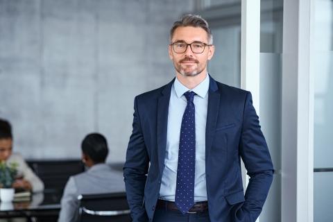 Successful mature businessman looking at camera with confidence stock photo