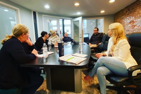 a group of coworkers working around a table