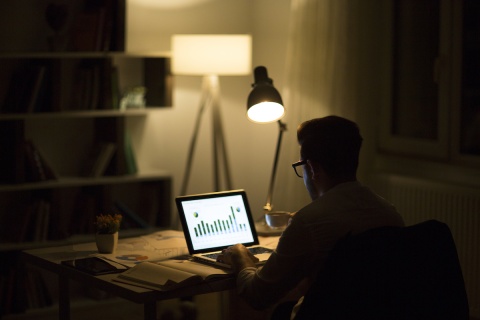 An independent insurance agent working late at night the become a successful agency owner.