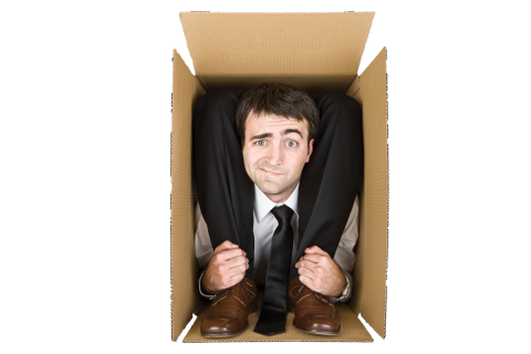 A business man folded into a box with a puzzled look on his face.