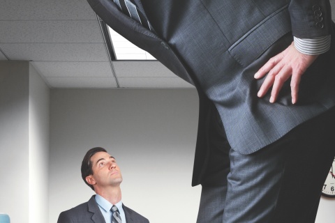 Independent insurance agent looking up at a much larger and taller agent.