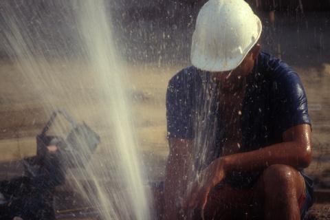 Man tries to stop water exploding from the ground