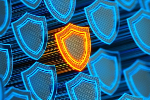 Futuristic digital background featuring a glowing yellow shield symbolizing protection, representing insurance agents' errors and omissions coverage to safeguard against data breaches and hacker attacks.