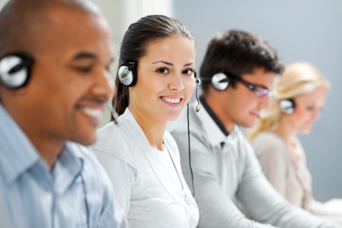 stock image featuring cheerful call center agents, illustrating the growing trend of insurance agency customer service outsourcing