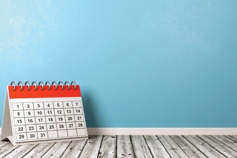 photo of a wall calendar propped up on the floor