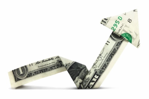 dollar bills folded into a zig zag arrow pointing upwards