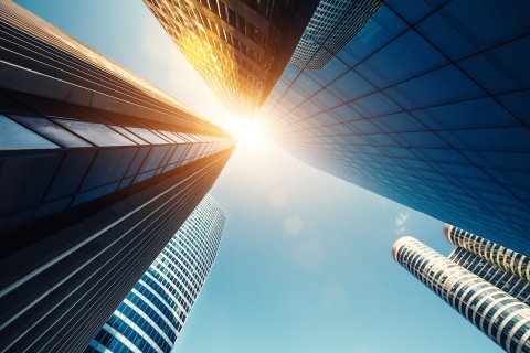 Skyscraper with the sun shining through.