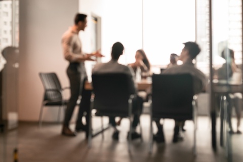 Blurry image of an independent insurance agency meeting to discuss their growth strategy.