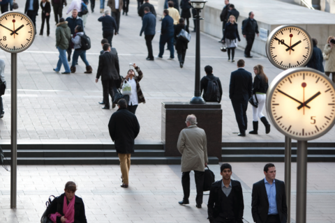 A busy day in the city, with crowds of people walking to and from work.