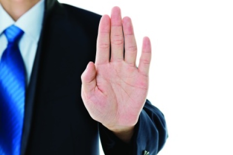 stock photo of a man holding his hand in a stop gesture